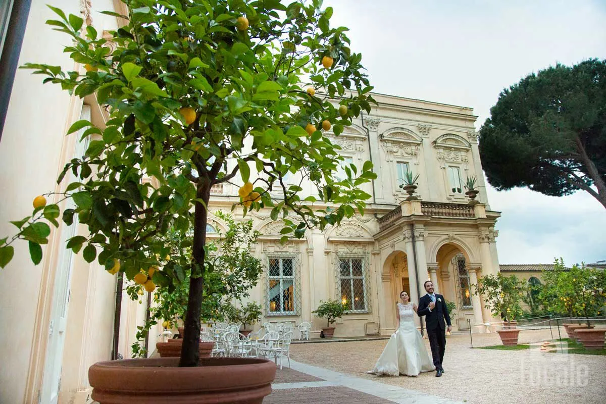 Sposi nel giardino di una villa storica accanto a un limone in vaso