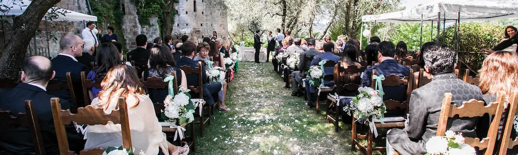 Cerimonia all’aperto con navata cosparsa di petali tra gli invitati